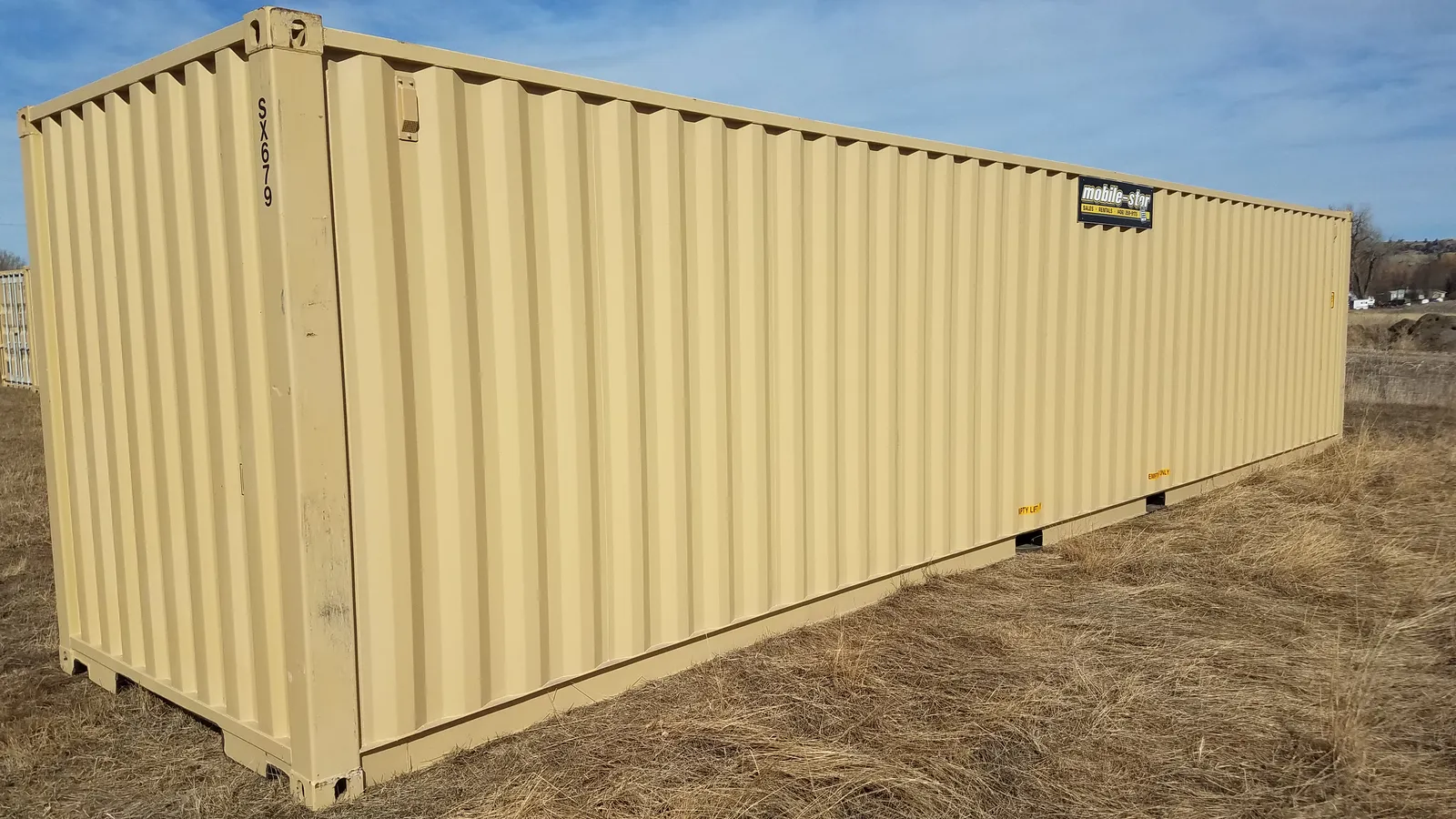 Tan Mobile-Stor shipping container photographed outdoors