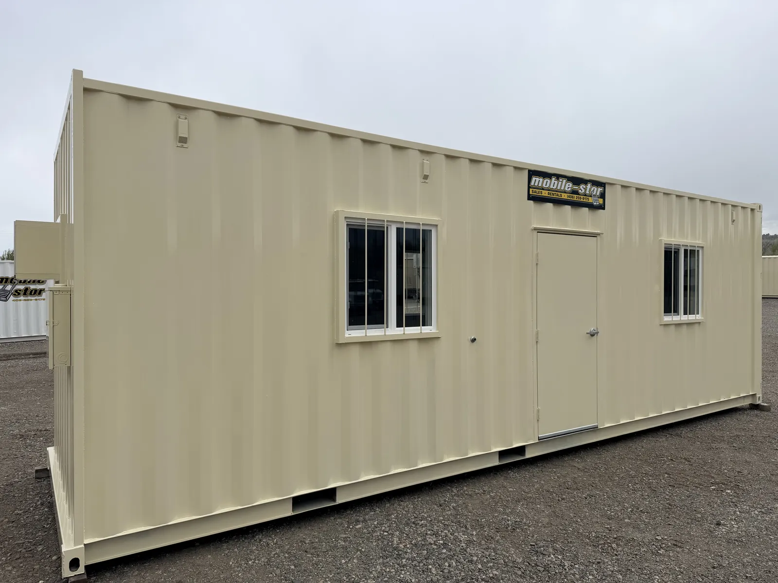 O-372 tan on-ground office with a ground-level entrance and two windows