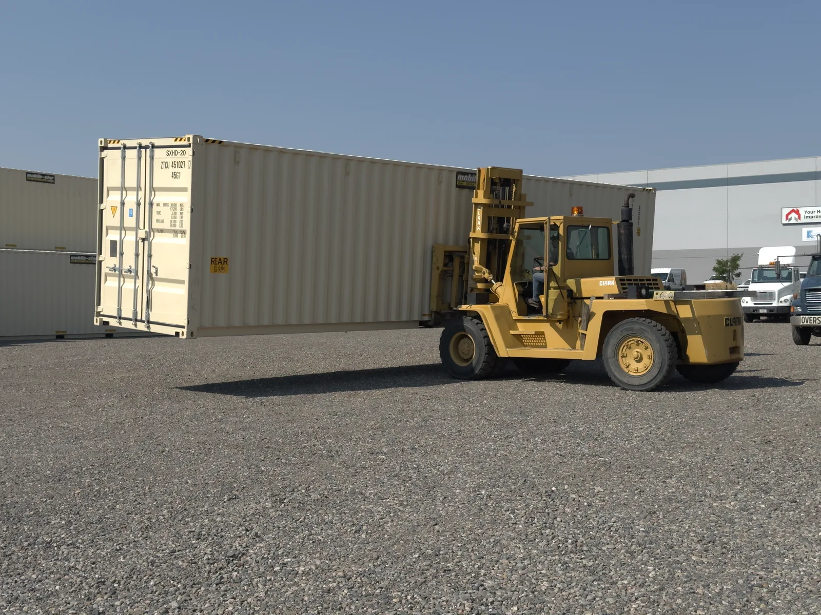 Mobile-Stor forklift lifting a shipping container in the Billings yard