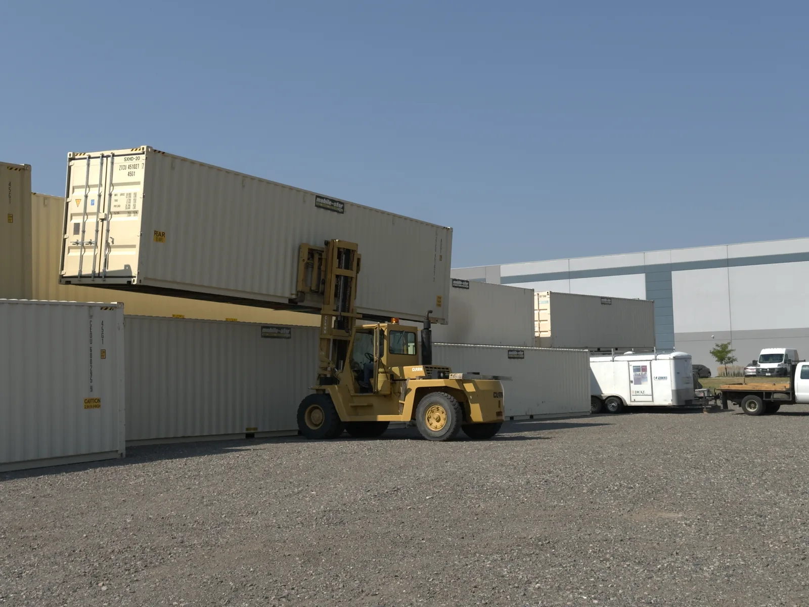 Mobile-Stor forklift working beside stacked shipping containers at the Billings yard