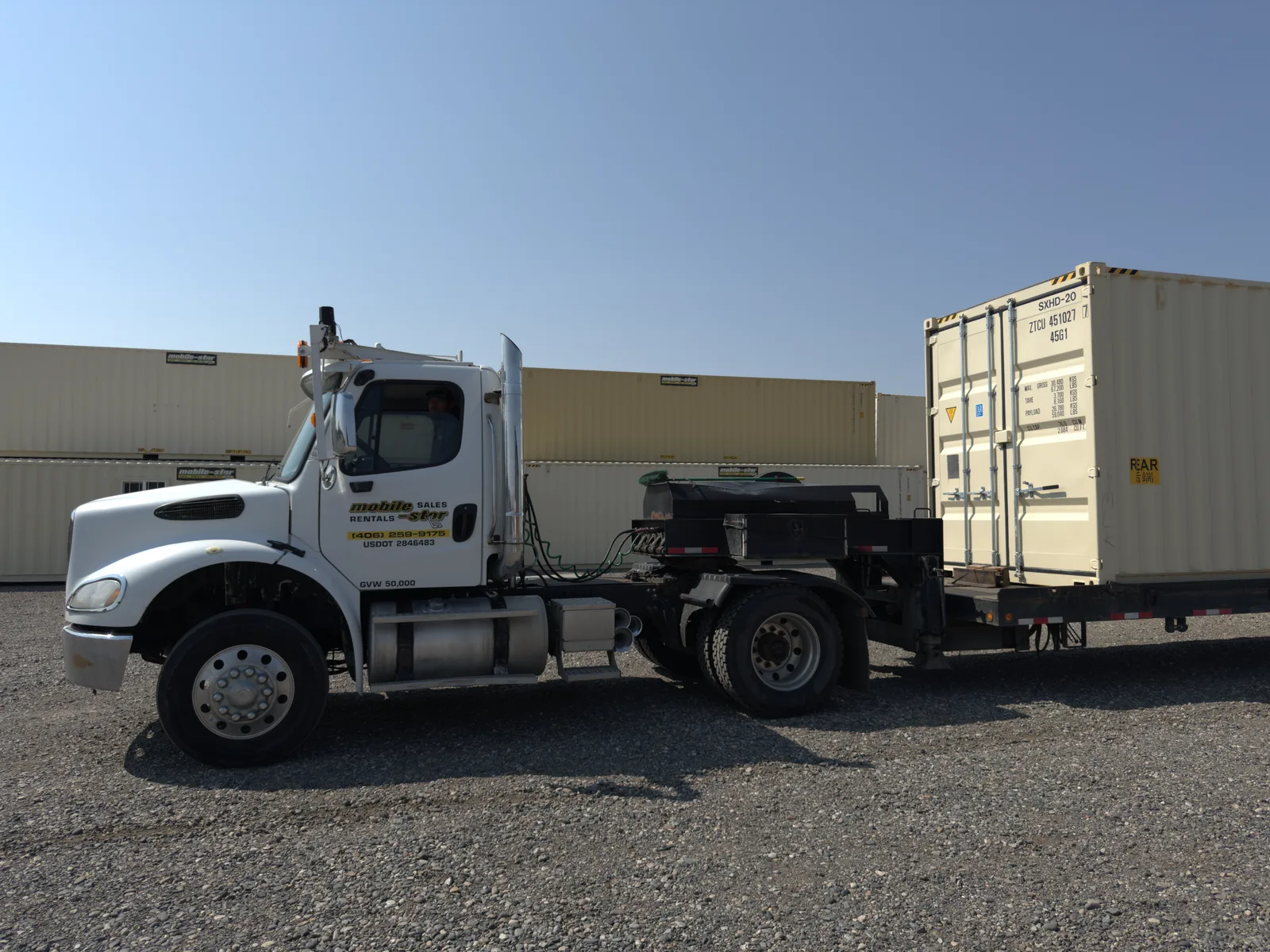 Mobile-Stor delivery truck transporting a shipping container from the Billings yard