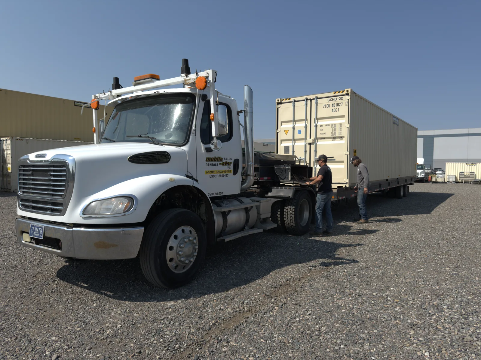 Mobile-Stor crew beside a shipping container and delivery truck